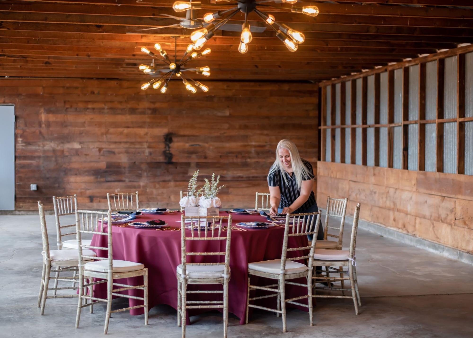 wedding planner setting up a tablescape for winter wedding in santa fe