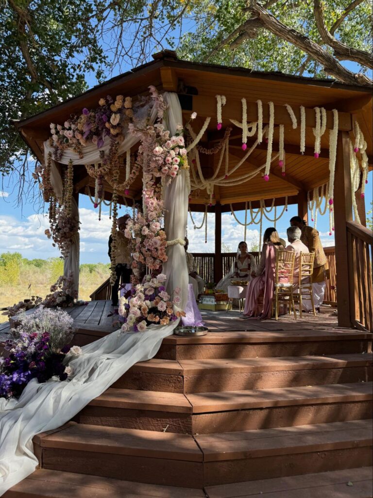 Floral-adorned gazebo for a wedding ceremony, highlighting the thoughtful decor options with full-service wedding planning.