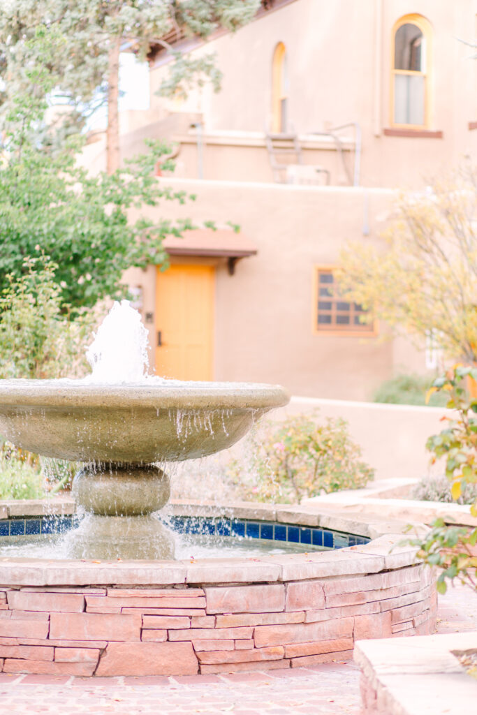 A peaceful courtyard fountain surrounded by adobe architecture—one of the serene outdoor spaces at La Posada in Santa Fe.