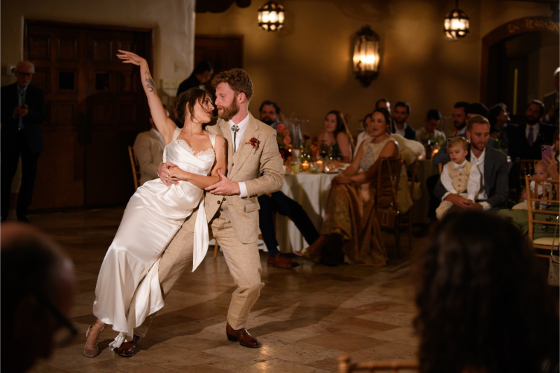 Bride and groom share first dance with a dramatic dip.