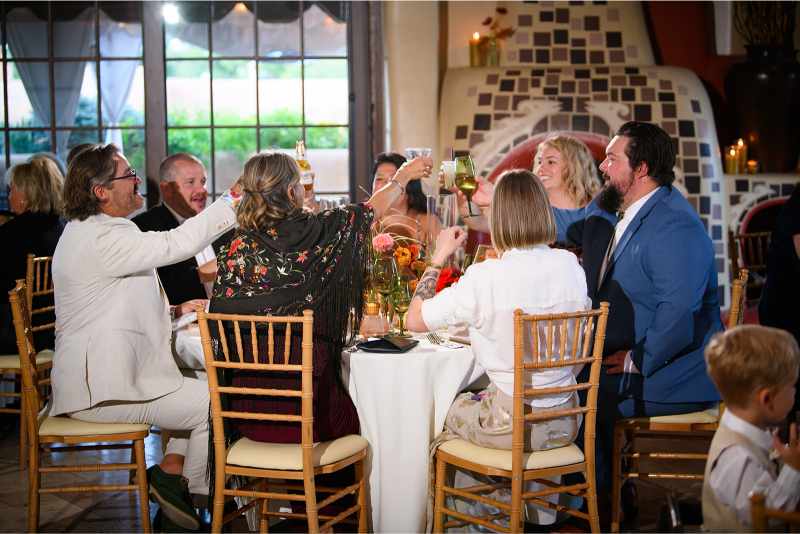 Guests cheer during wedding reception, their guest experience elevated by a cohesive weekend of events.