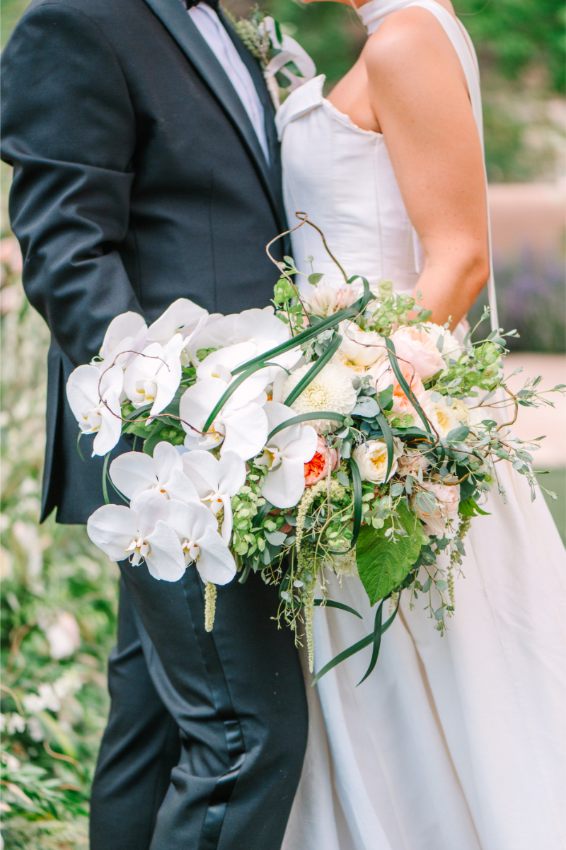 Bride and groom hold luxury flower bouquet for wedding portraits in Santa Fe.