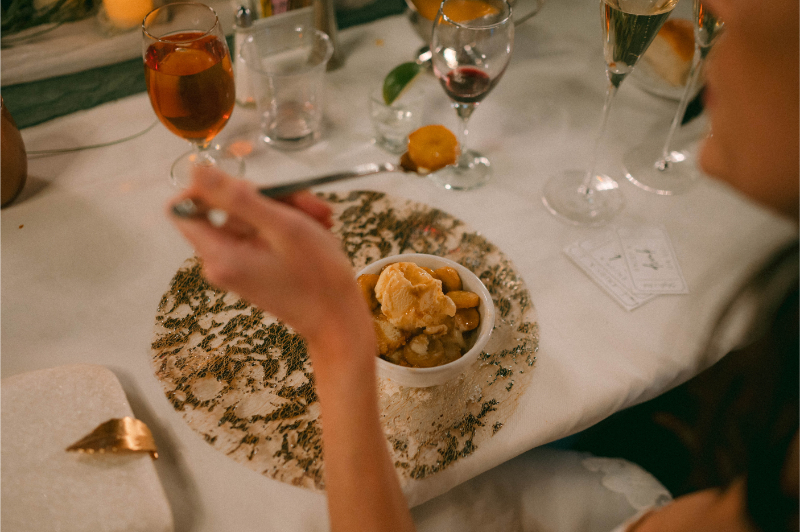 Guest enjoys bananas foster dessert at wedding reception, one of the couple's favorite unconventional wedding ideas.