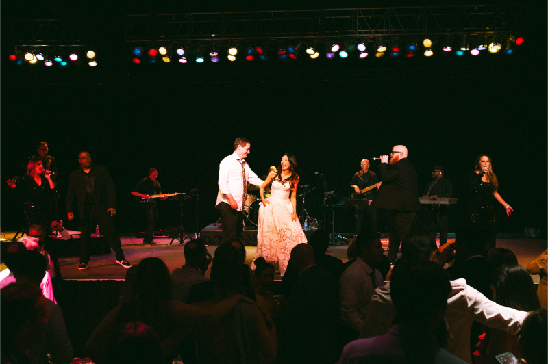 Bride and groom give speech on stage at the end of the reception.
