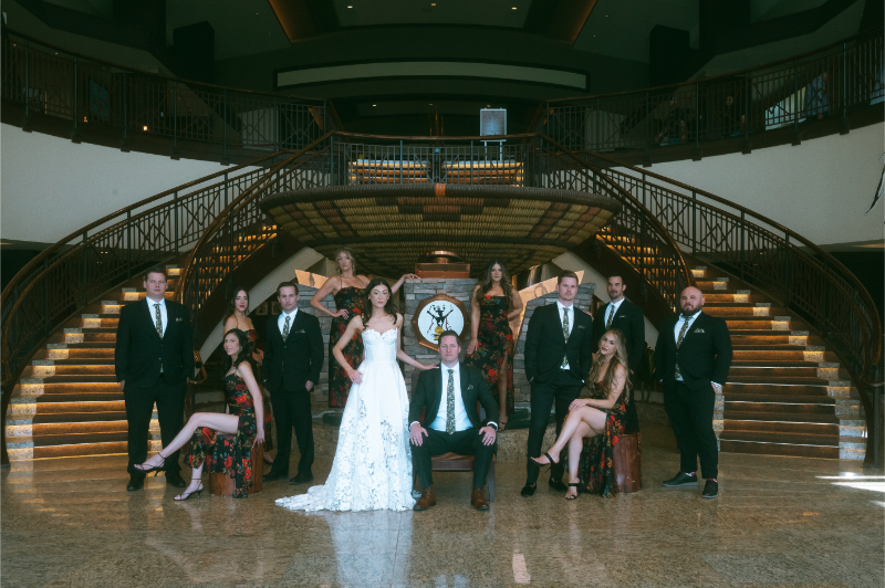 Bridal party stands for group portrait in their coordinated outfits, one of the couple's favorite unconventional wedding ideas.
