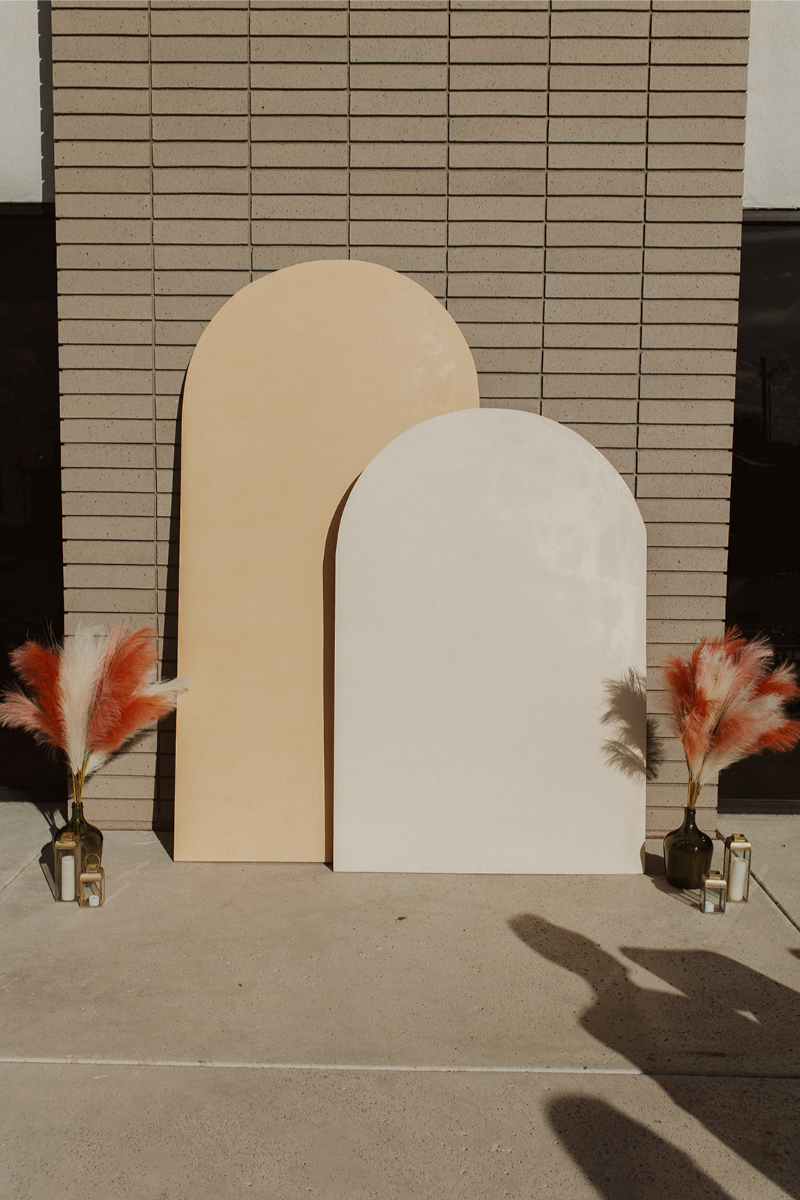 Arch backdrop ceremony decor for fall wedding in New Mexico.