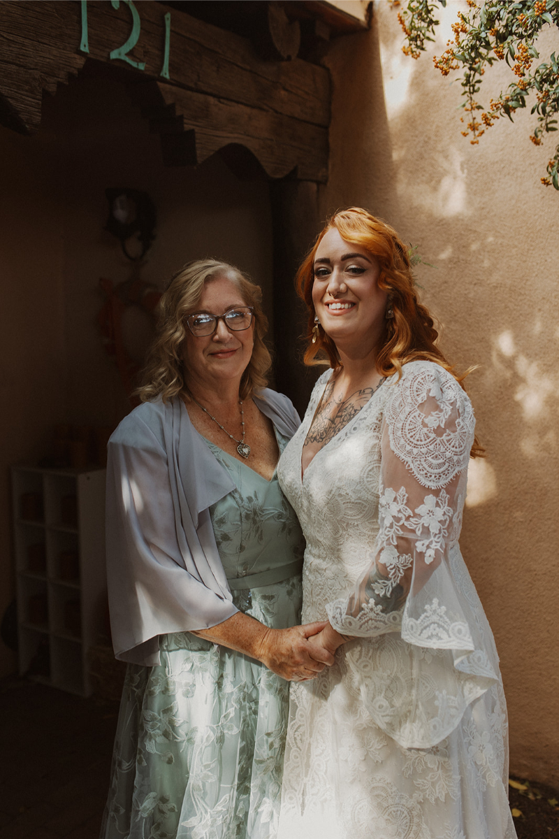 Bride and mother pose for photo during New Mexico wedding.