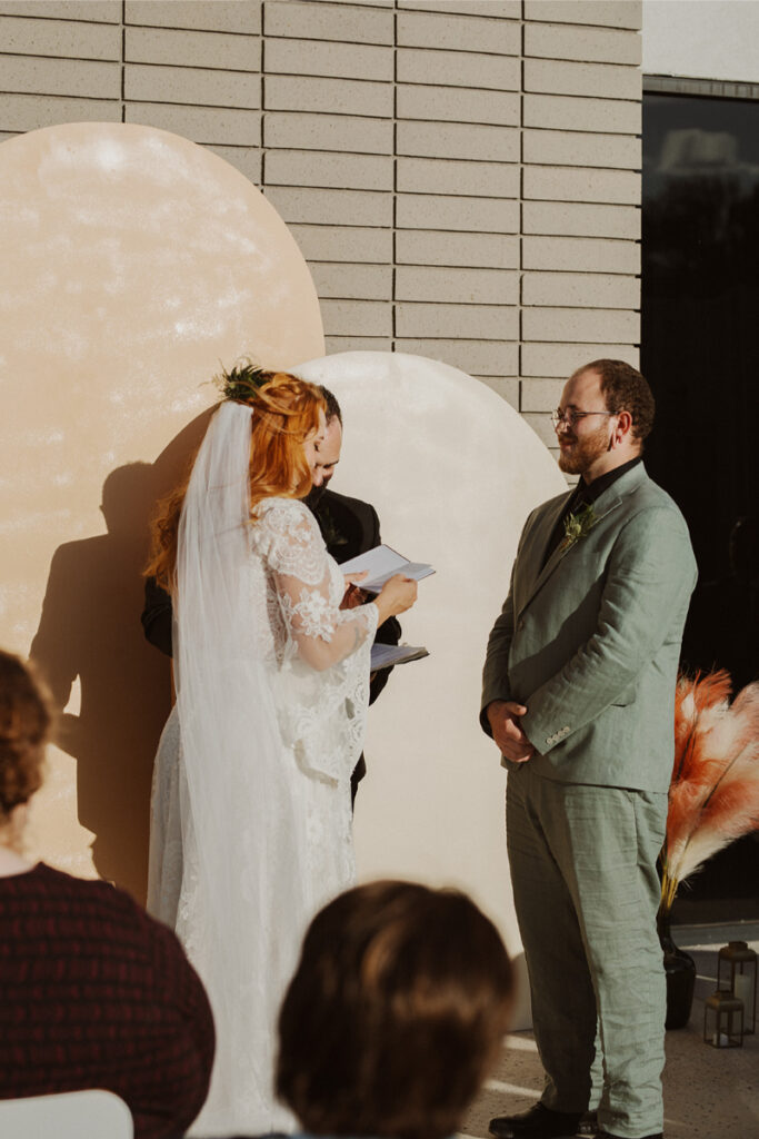 Bride and groom exchange vows during fall wedding in New Mexico.
