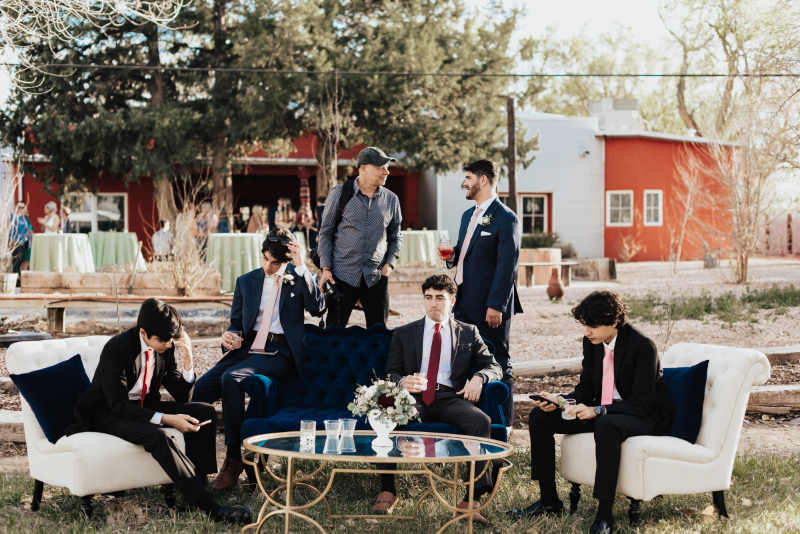 Guests using lounge wedding rentals at New Mexico reception.