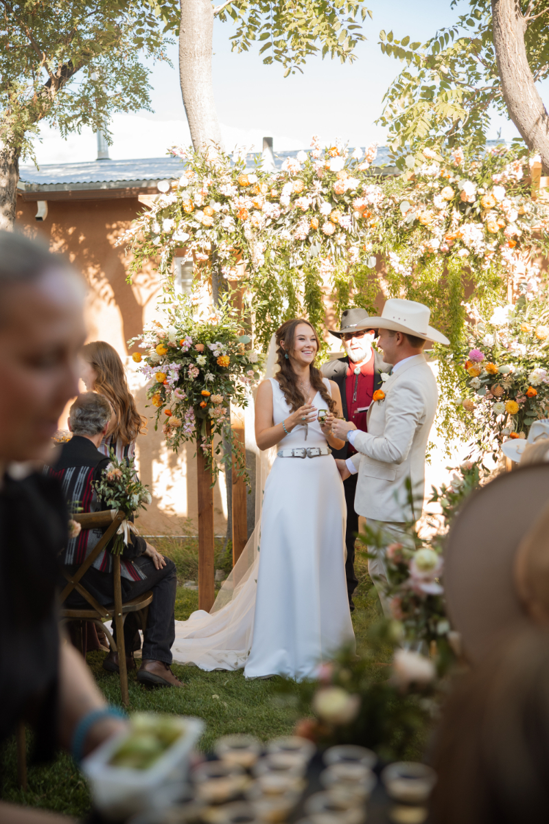 Couple gets ready to share tequila shot as part of their unity ceremony, an event on their wedding weekend itinerary.