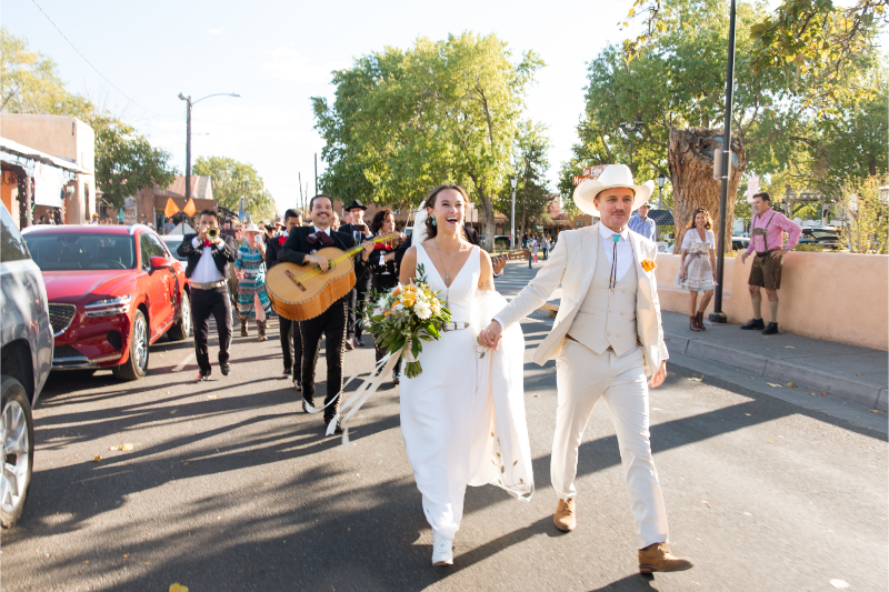 Bride and groom lead mariachi band before cocktail hour in Albuquerque. 