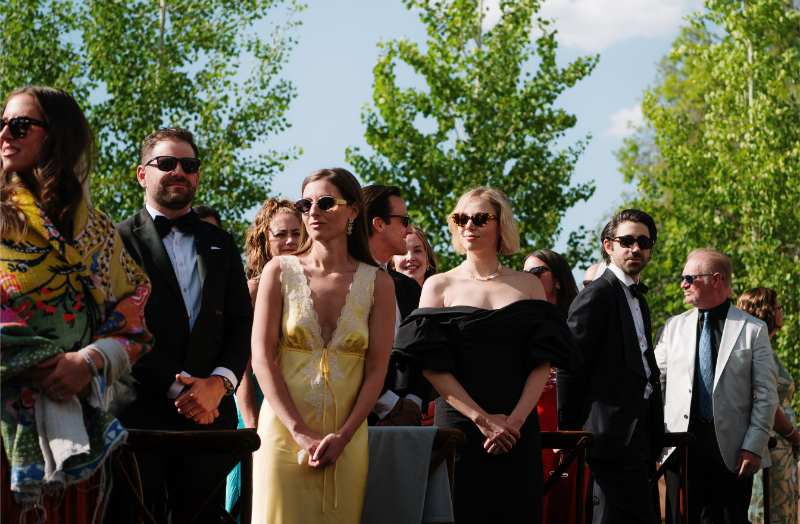 Guests watch bride and father walk down the aisle.