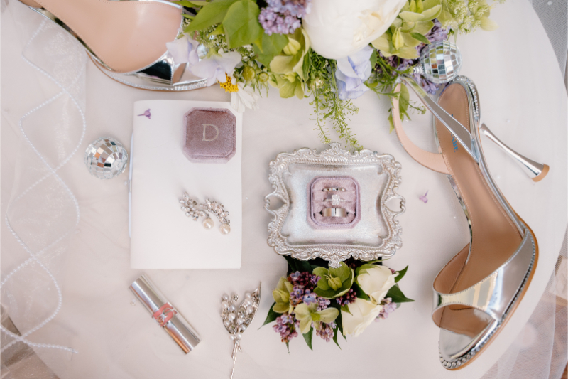 Flatlay of bridal accessories used in colorful wedding themes.
