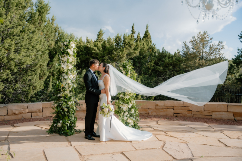 Bride and groom kiss during portraits.