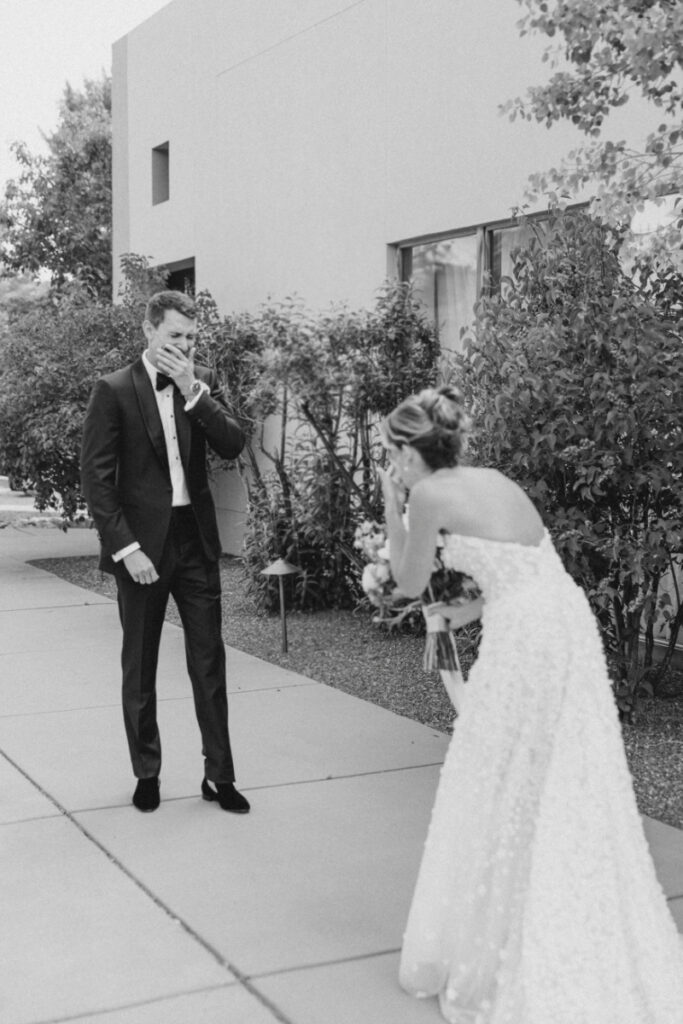 Bride and groom sharing first look, very ecstatic. They are completely in the moment because they searched what does a wedding planner do and hired a planner for their big day.