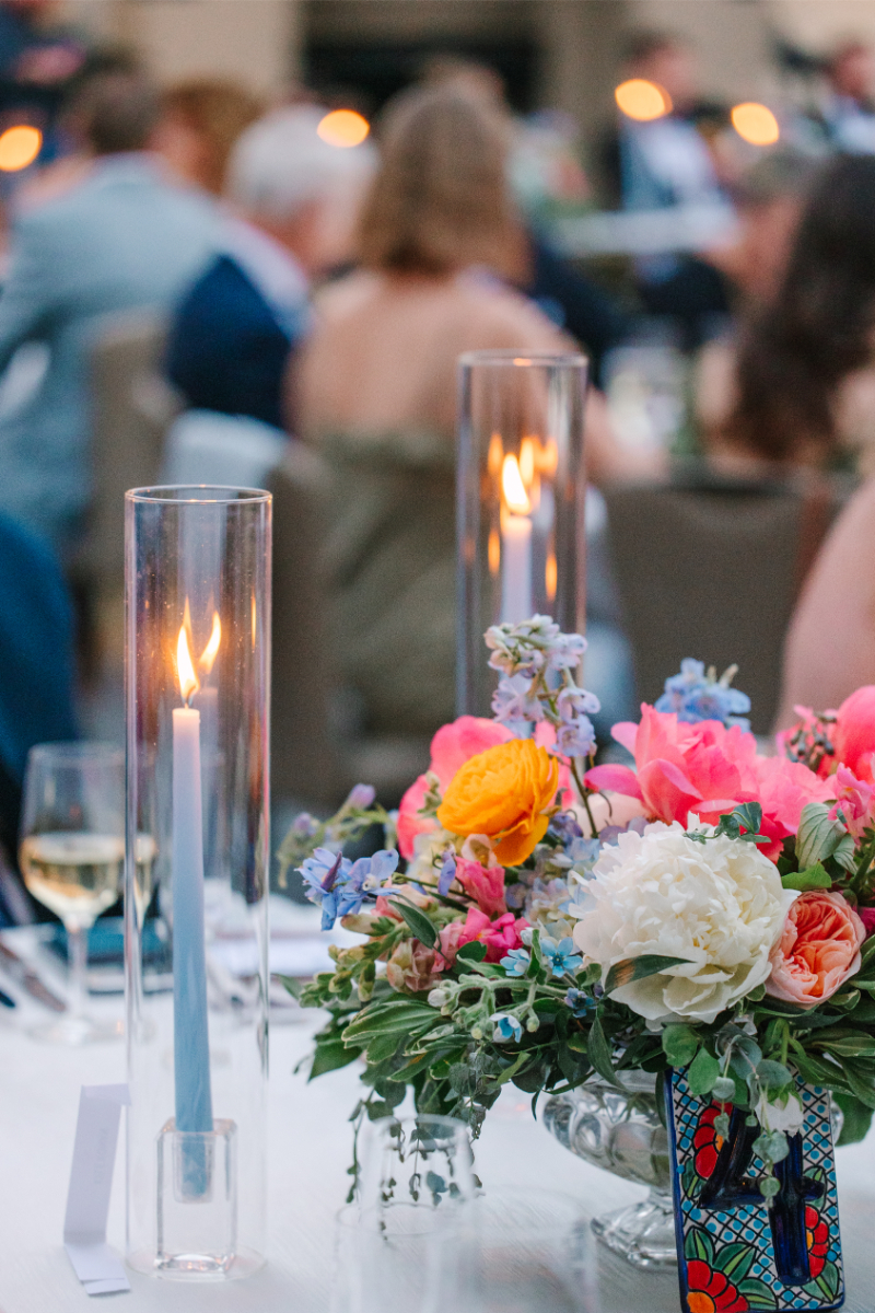 Centerpiece with colorful florals and taper candles for wedding in New Mexico.