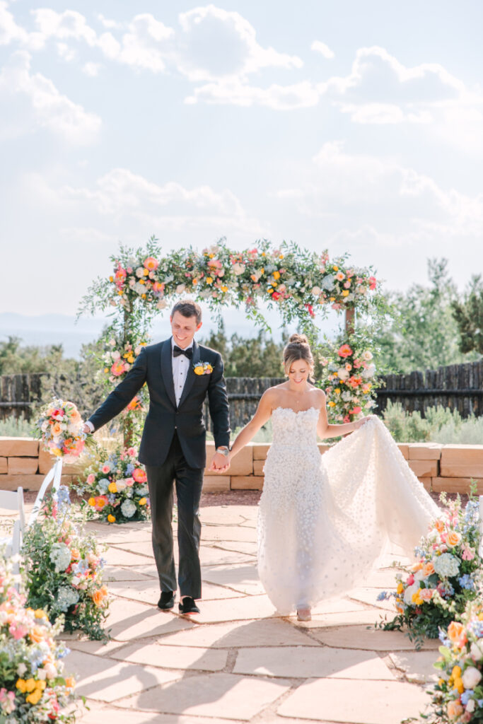 Couple walks down aisle together after tying the knot. 