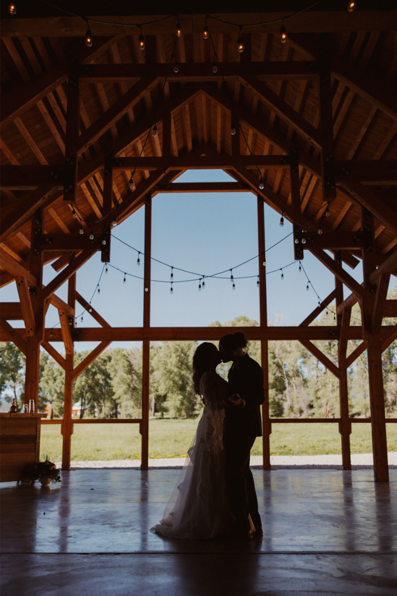 Couple share kiss during first dance.