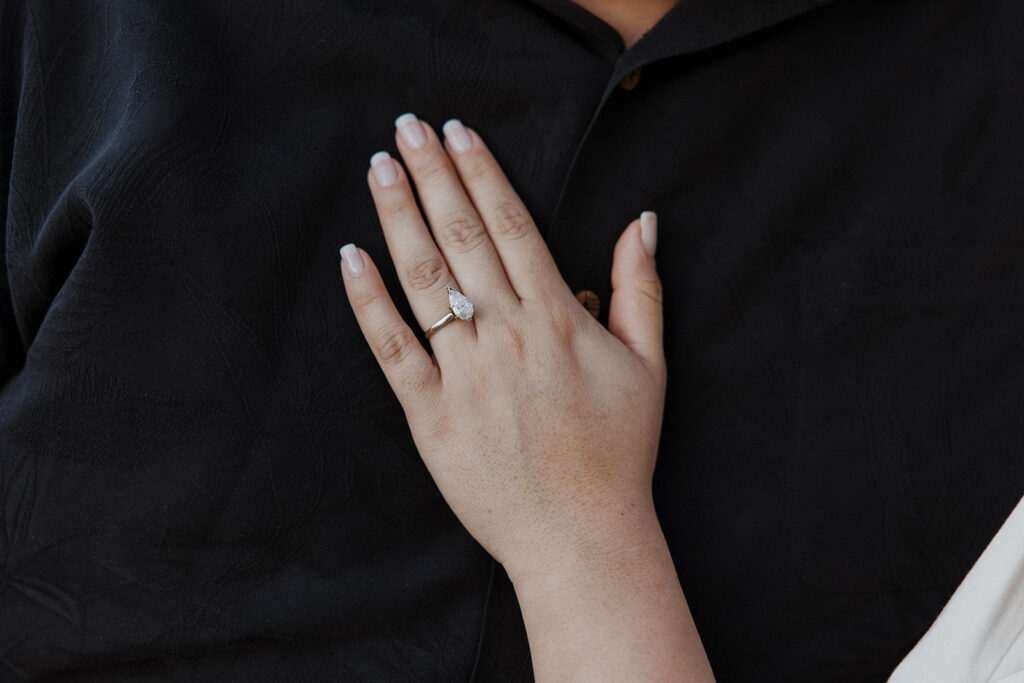 Girlfriend places hand on boyfriend's chest, showing off the ring from his Nashville proposal ideas that he executed.