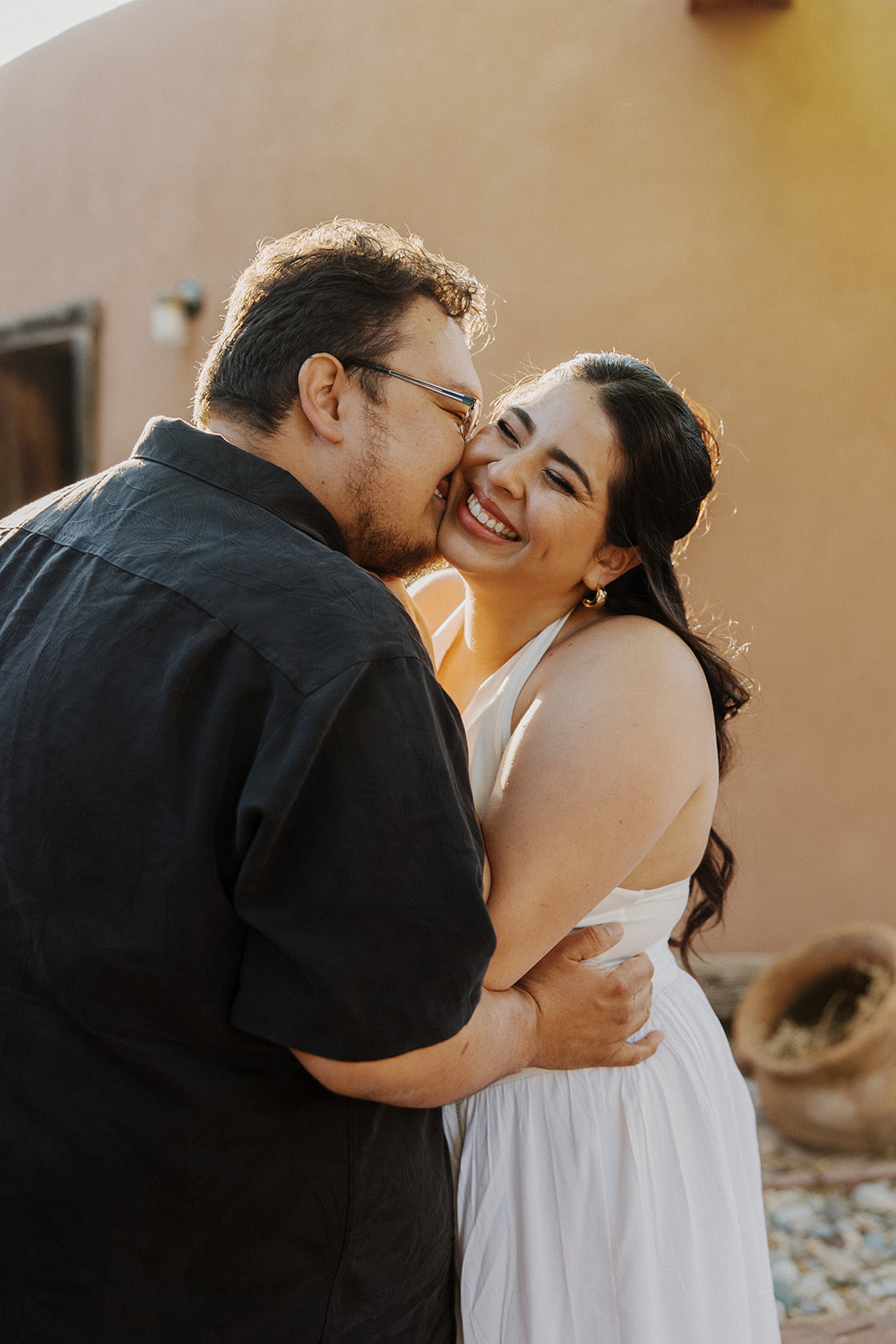 Boyfriend kisses his girlfriend on the cheek after his proposal ideas were executed flawlessly.