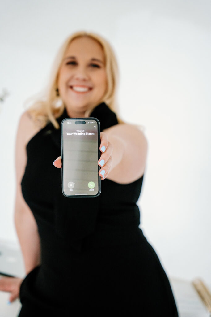 Taylor Fail, Verdeaux & Co.'s owner and lead planner, holds phone toward camera as she gets a call that says "your Nashville wedding planner."
