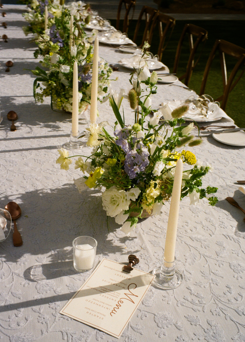 Low floral centerpiece on reception table for garden wedding at Bishop's Lodge in Santa Fe.
