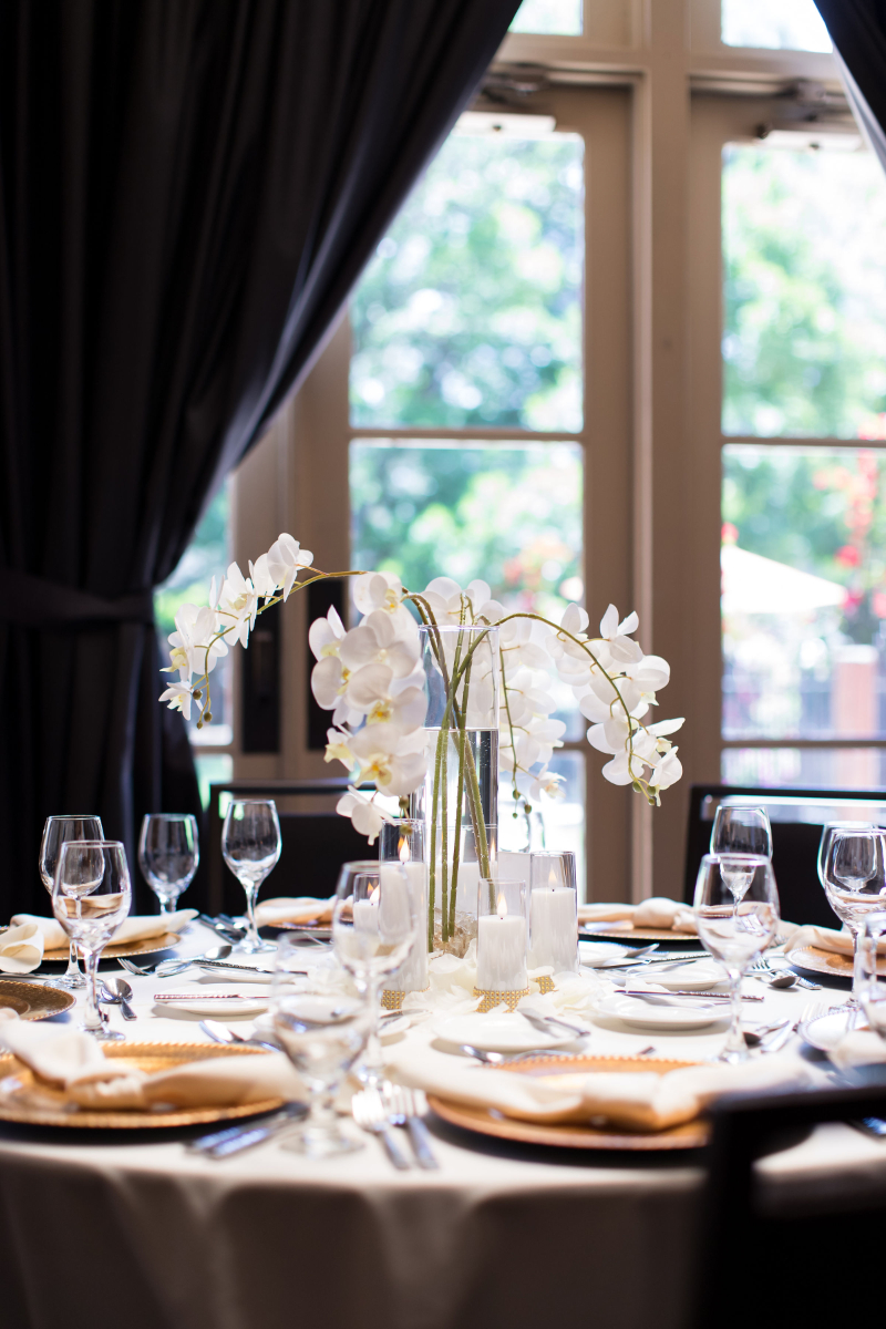 White floral centerpiece for wedding reception.