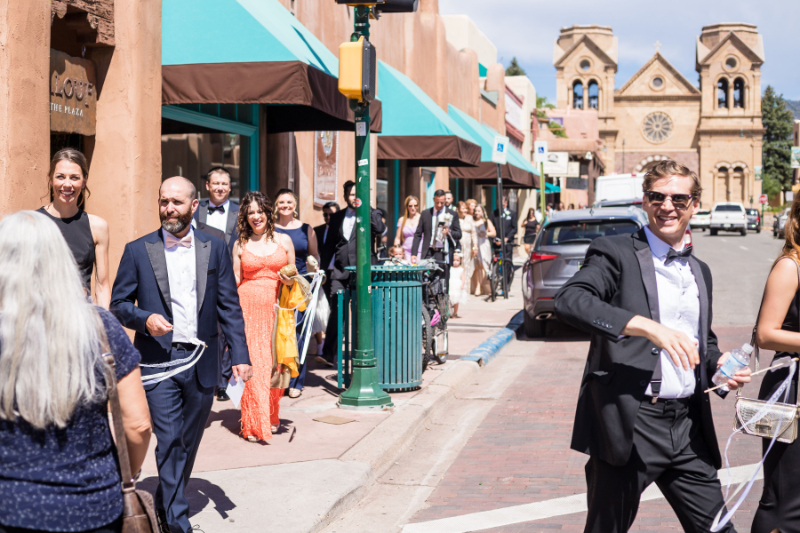 Mariachi band leads guests through downtown Santa Fe to cocktail hour at the Inn and Spa of Loretto.