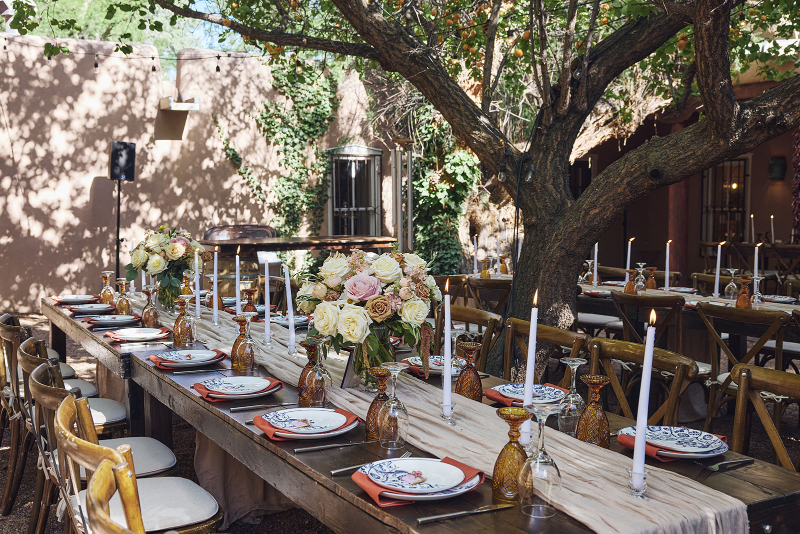 Table setting decorated for backyard wedding reception.