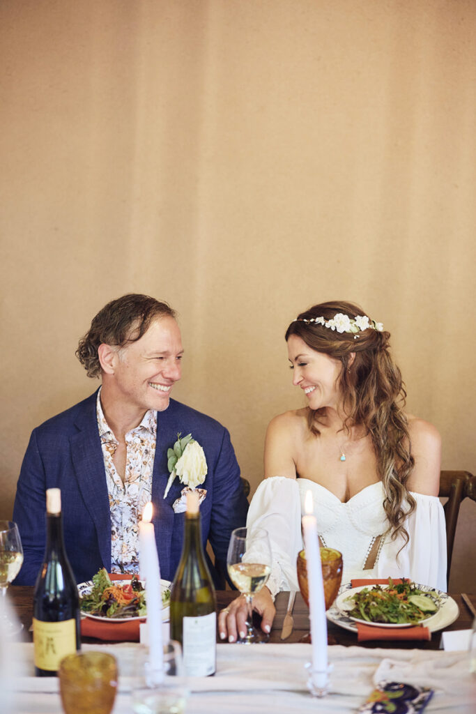 Bride and groom share loving glance during their wedding reception.