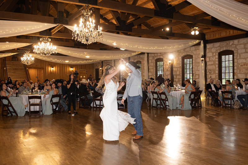 Bride and groom share first dance in front of seated wedding guests, everyone taking in the moment as the Tennessee wedding planner team made everything come together behind the scenes.