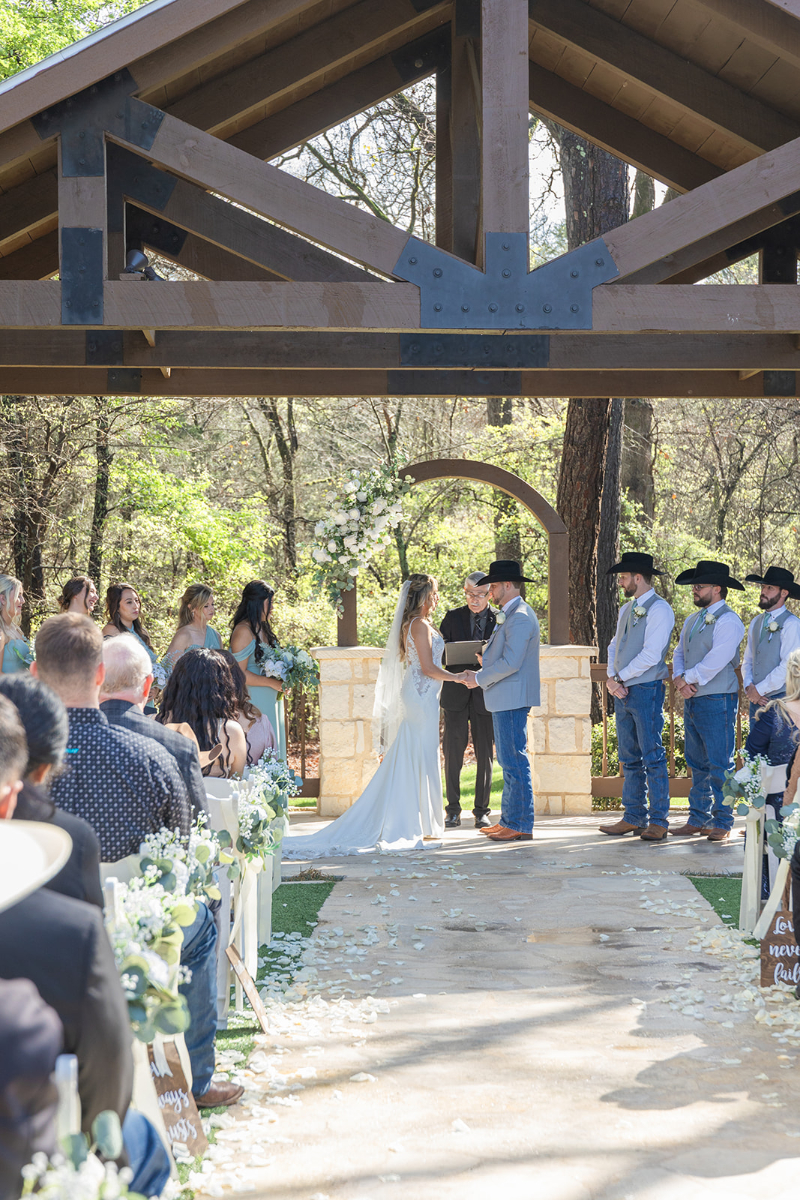Bride and groom hold hands at the altar, fully enjoying the moment since their Tennessee wedding photographer handled all the logistics of the day.