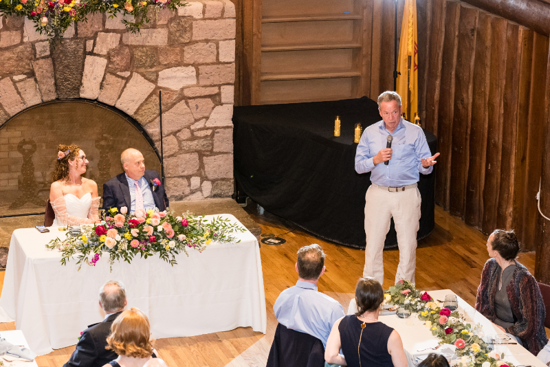Guest gives speech during wedding reception.