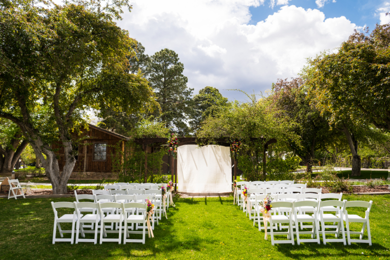 Intimate wedding ceremony set up on lawn of New Mexico venue.