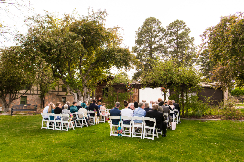Guests sit in white folding chairs waiting for intimate ceremony at a New Mexico wedding.