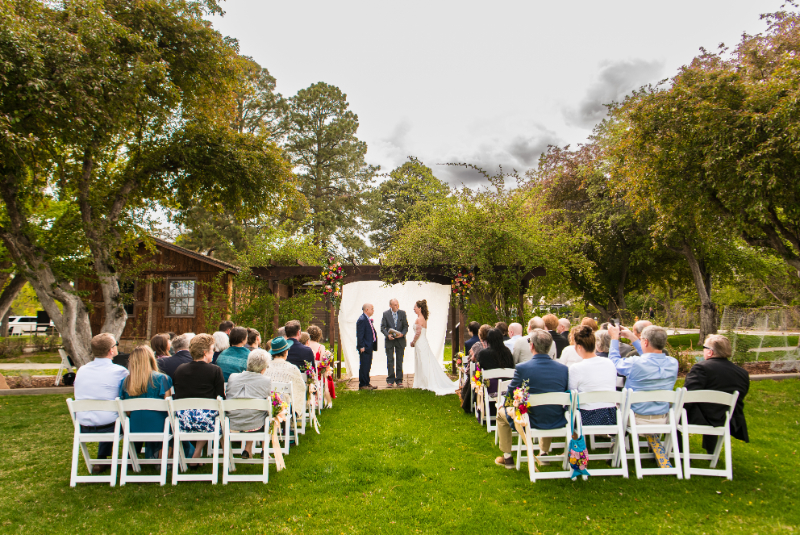 Bride and groom exchange vows during intimate wedding ceremony in New Mexico.