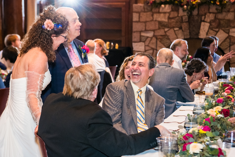 Bride and groom walk around talking to each of their guests, a benefit of hosting an intimate wedding.