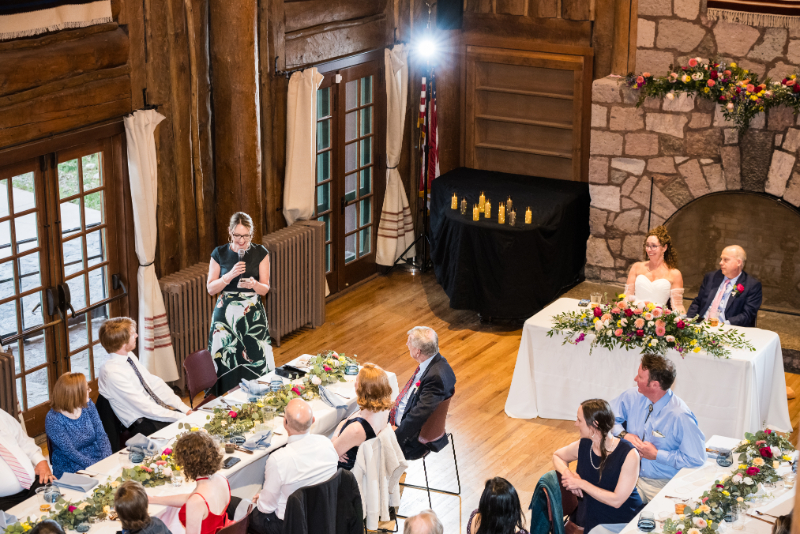 Guest gives speech during intimate wedding reception.