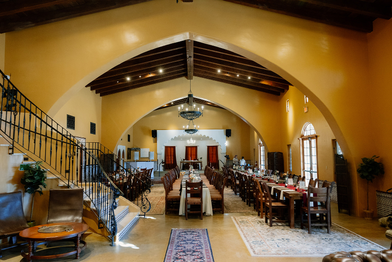 Mansion wedding venues decorated for reception with long tables.