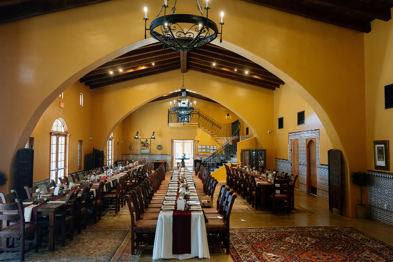 Mansion wedding venues decorated for reception with long tables.