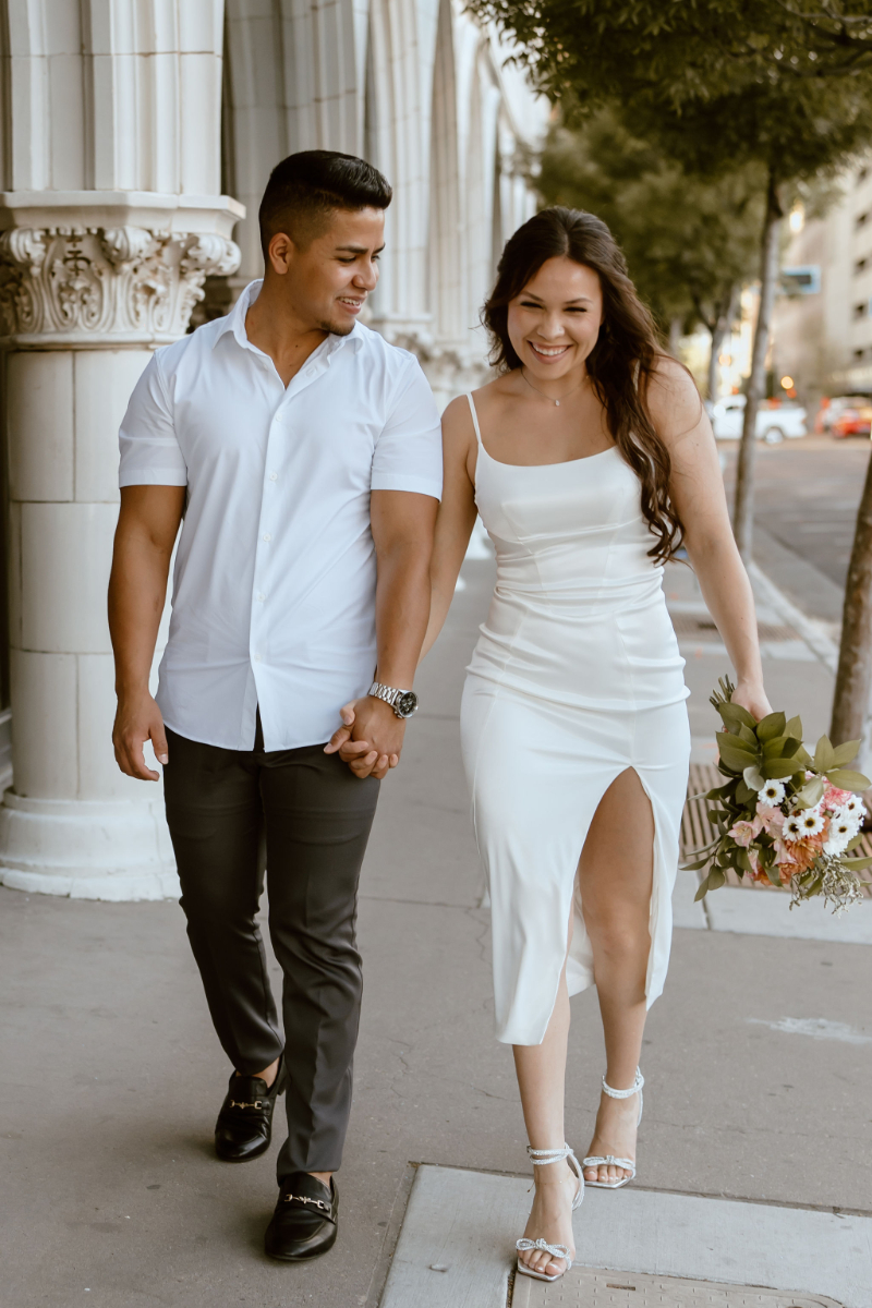 Couple walks together hand in hand during their engagement session in New Mexico, one of the first to-do's on their wedding planning timeline.