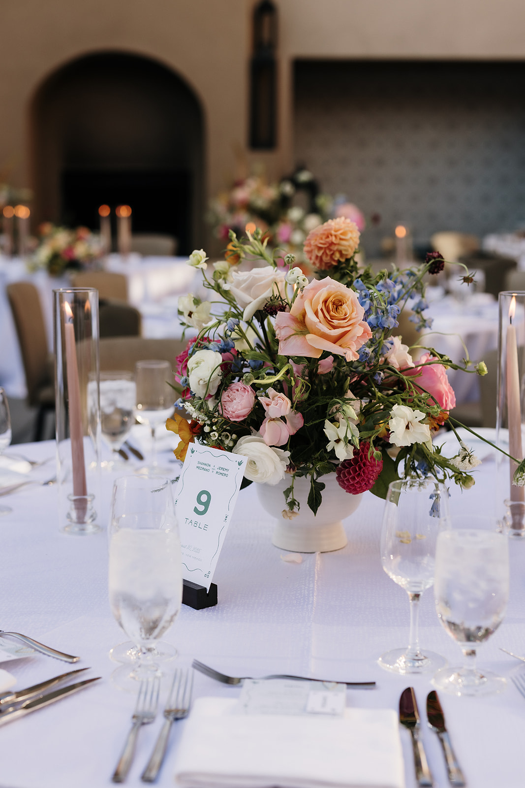 Floral arrangement centerpiece on wedding reception table.