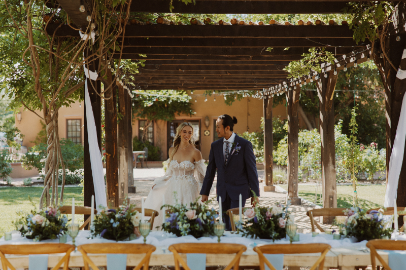Bride and groom admire their French Chateau wedding style-inspired tablescape.