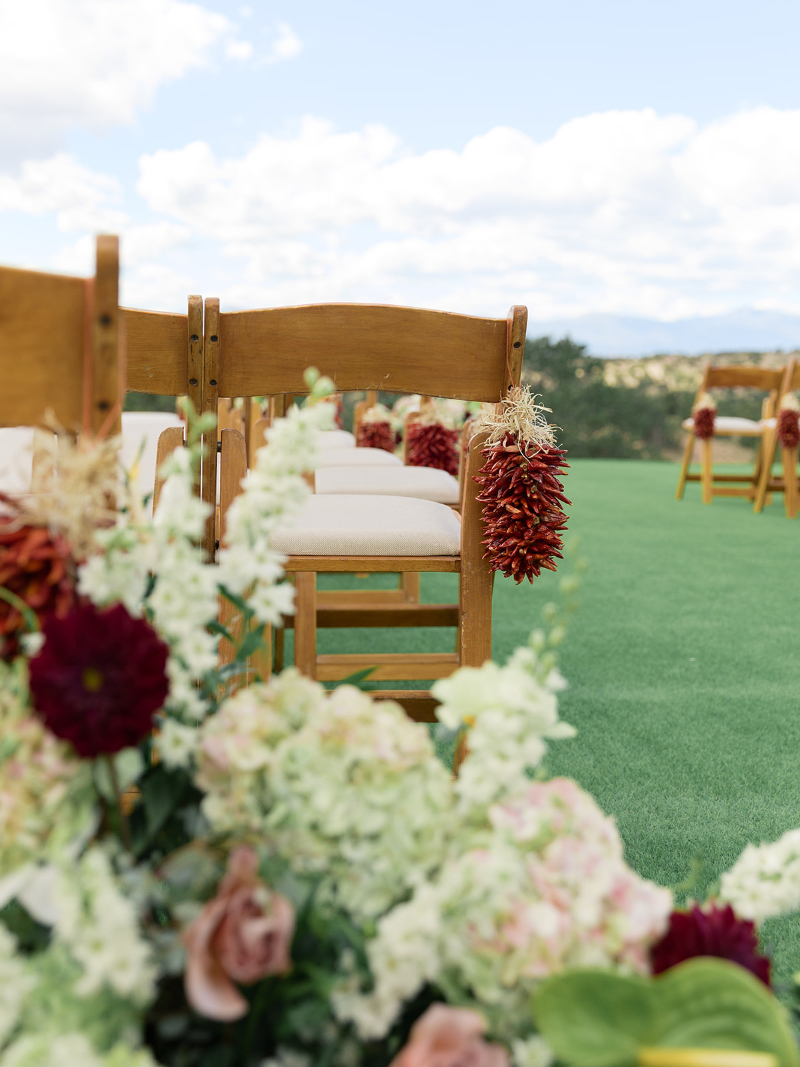 Detail of florals lining the aisle of ceremony.