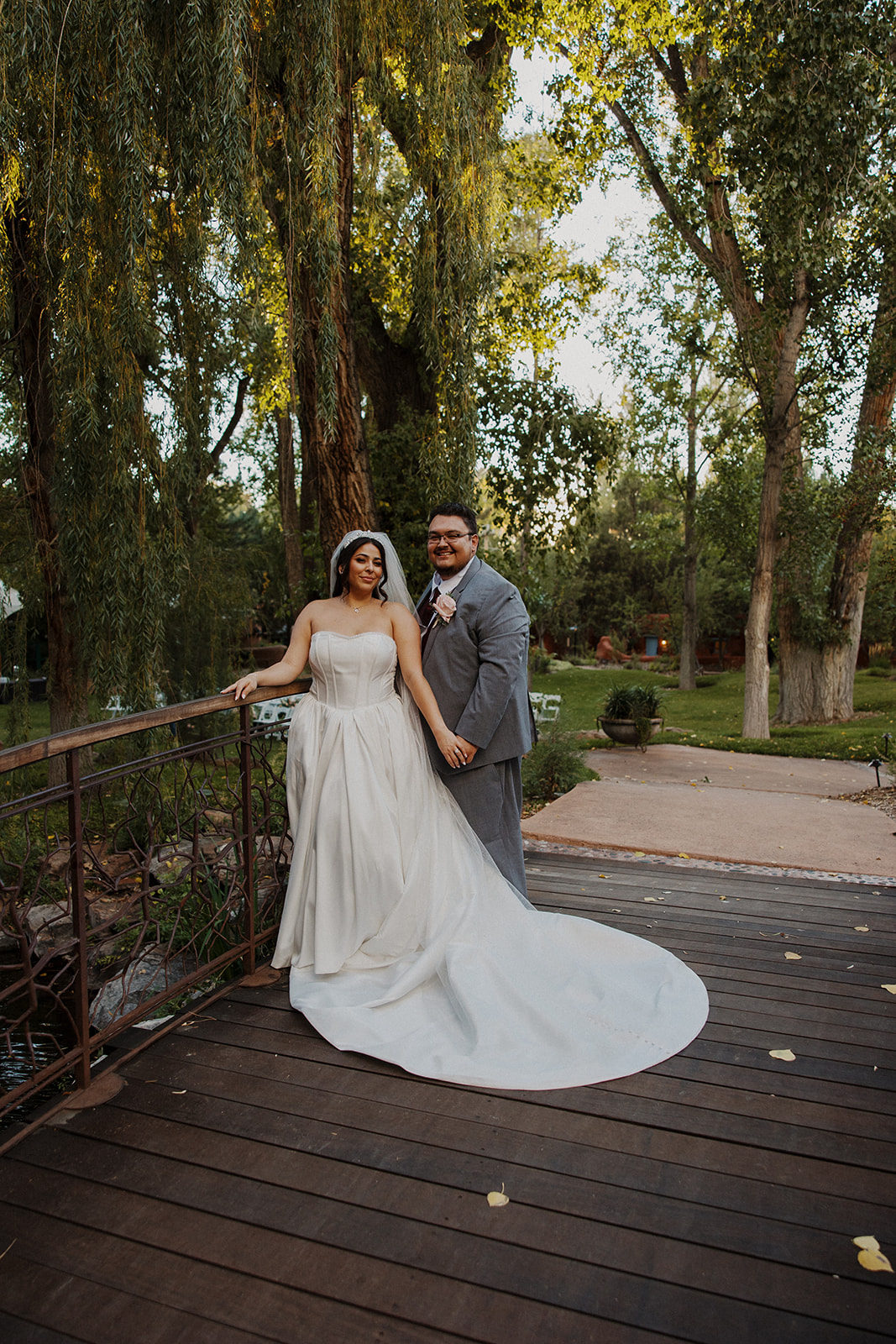 Bride and groom pose together on a bridge in their Tennessee mountain wedding venue.