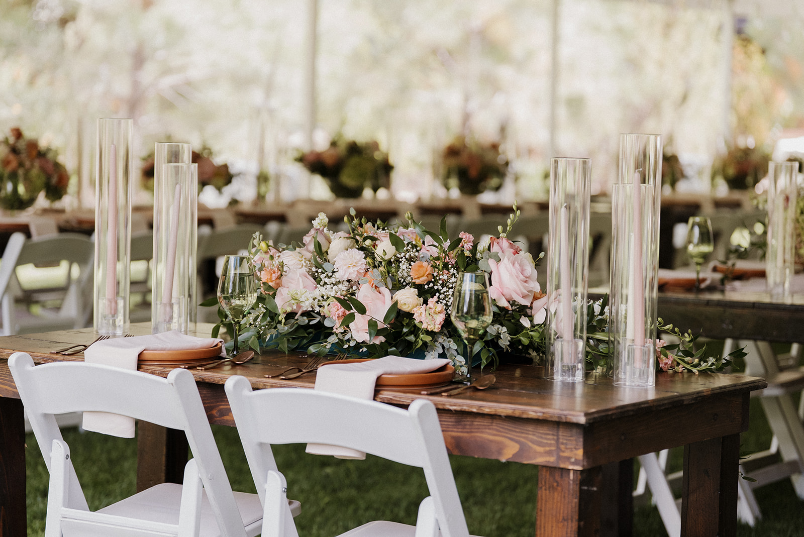 Sweetheart table for Tennessee mountain wedding decorated with votive candles and spring florals.