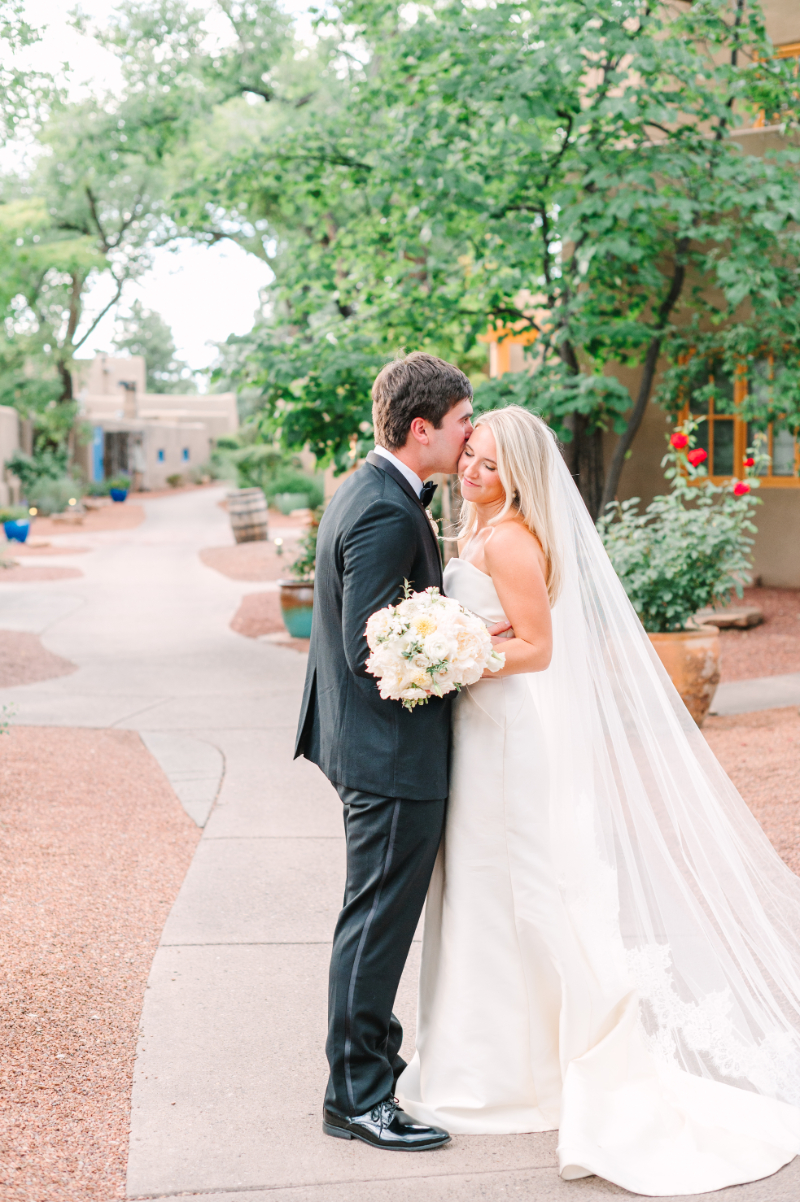 Bride and groom pose for portraits with bride holding her bouquet, a perfect example of bridal bouquet ideas brought to life.