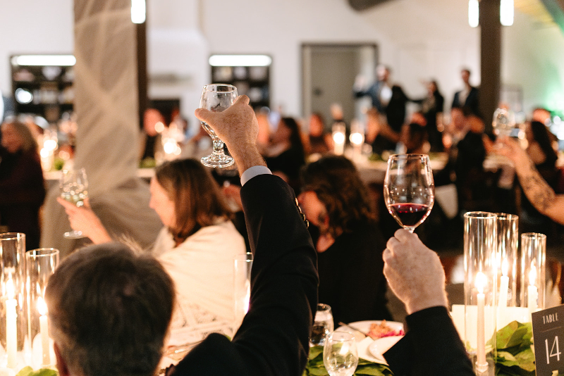 Guests raise their glass to toast the brides celebrating their wedding at one of the most popular Knoxville wedding venues.