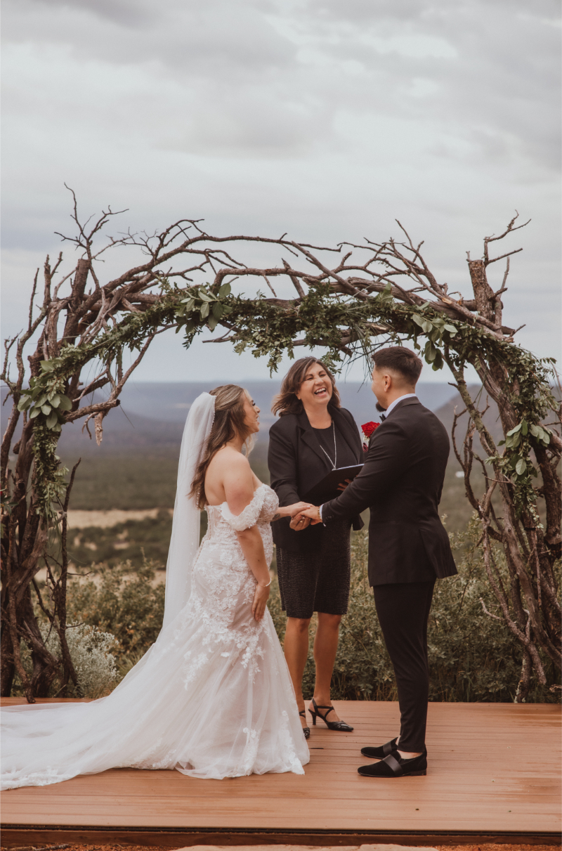 Bride and groom stand at altar overlooking the gorge at their Chattanooga wedding venues ceremony site with a branch arch.