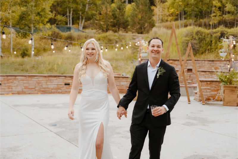 Bride and groom hold hands as they enter their outdoor wedding venues in New Mexico for cocktail hour.